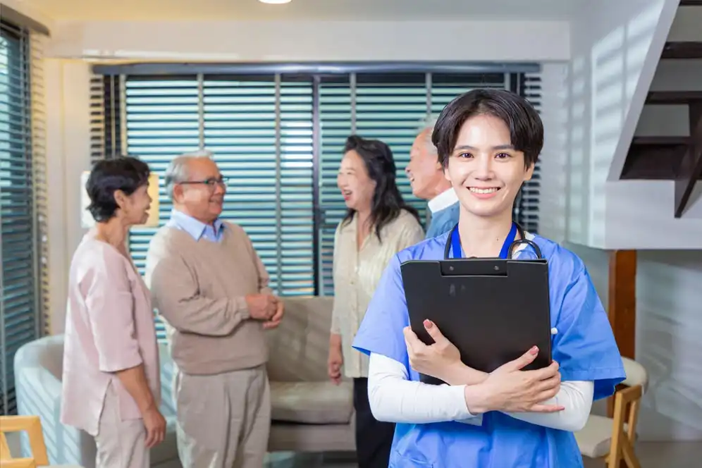 Caretaker with the elderly in the background